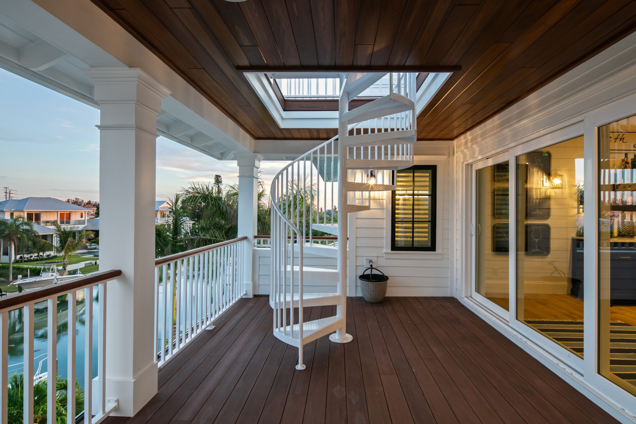 Covered porch with a spiral stair to the rooftop deck