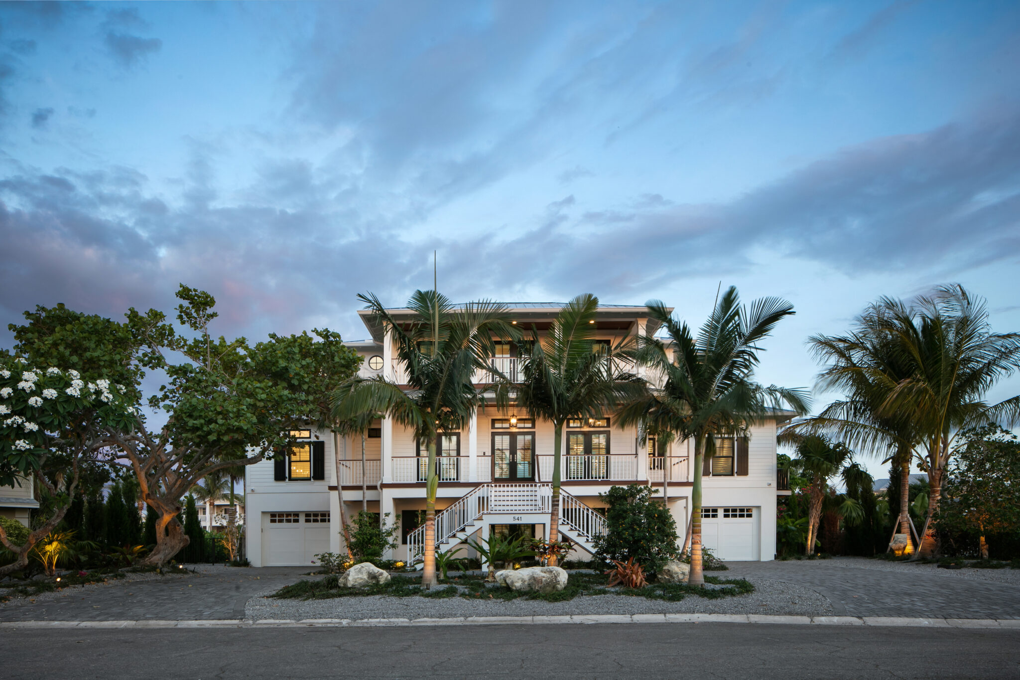 Front of Coastal Haven at dusk with a lit motor court