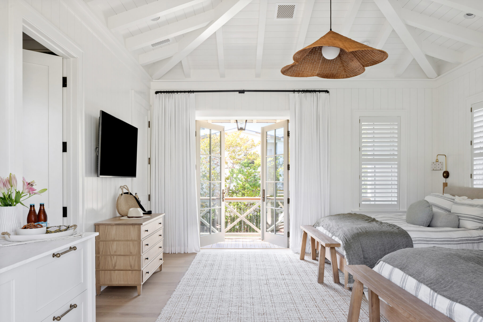 Bunk room with twin beds and French doors to a balcony