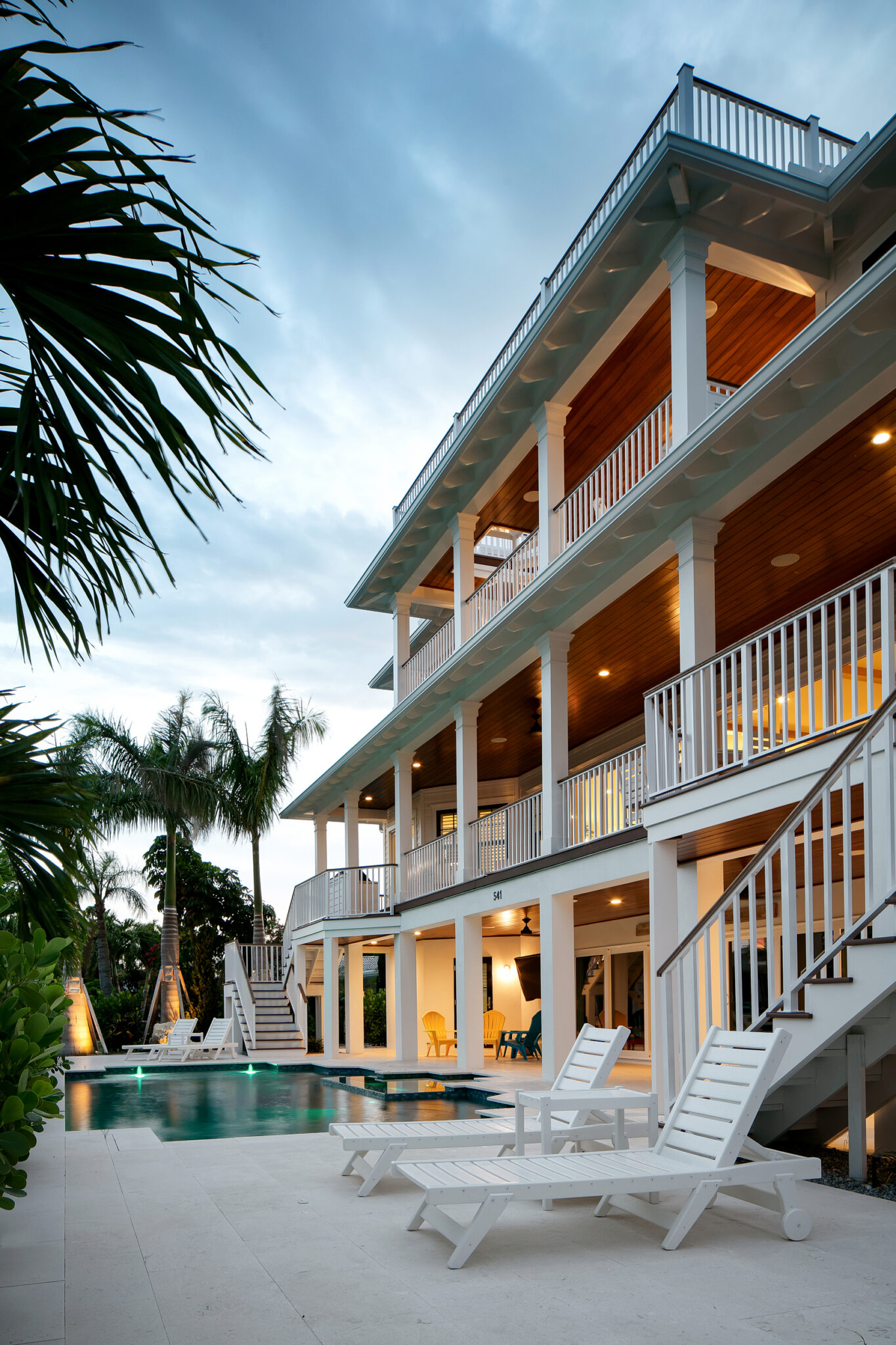 Rear porches and pool deck of Coastal Haven at dusk
