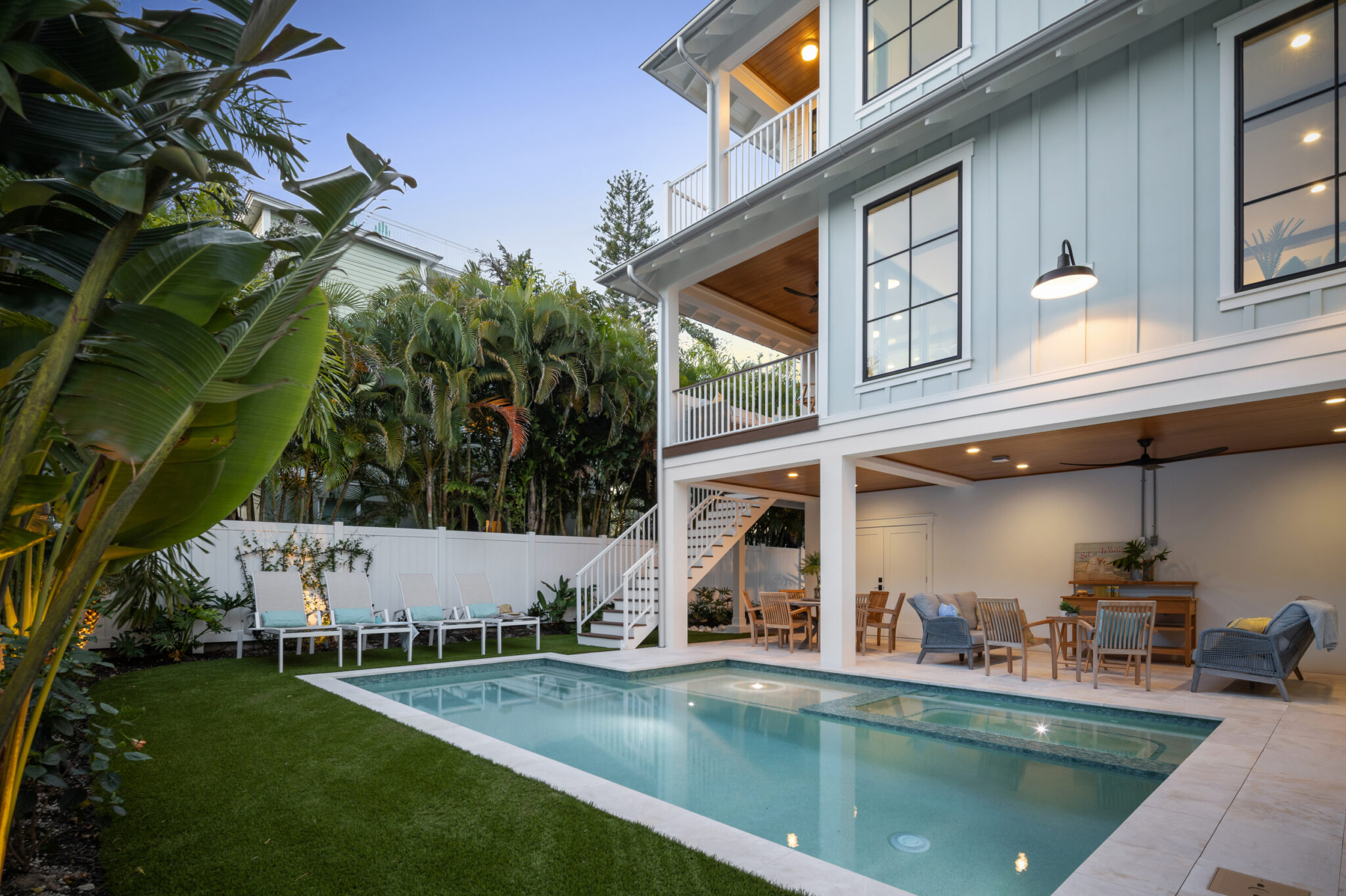 Pool and lawn behind Beachwalker at dusk
