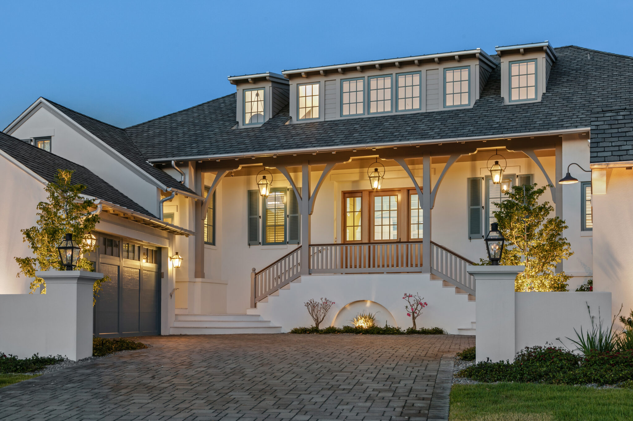 Front entry stair and porch of Blue Heron, lit at twilight