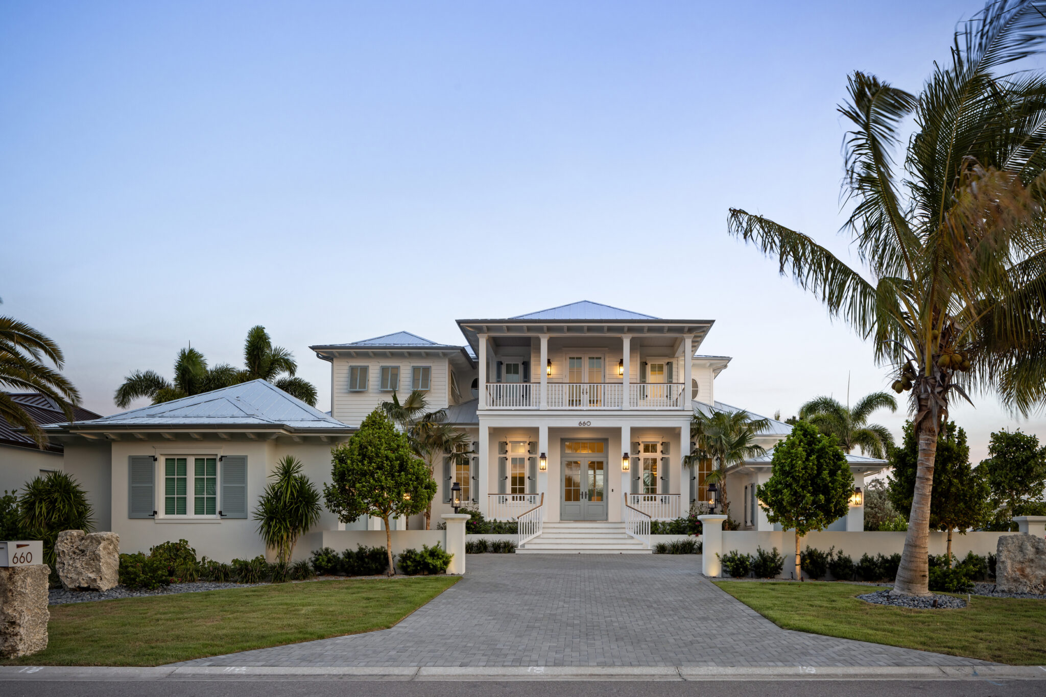Front of Harbor House at dusk with a paver motor court