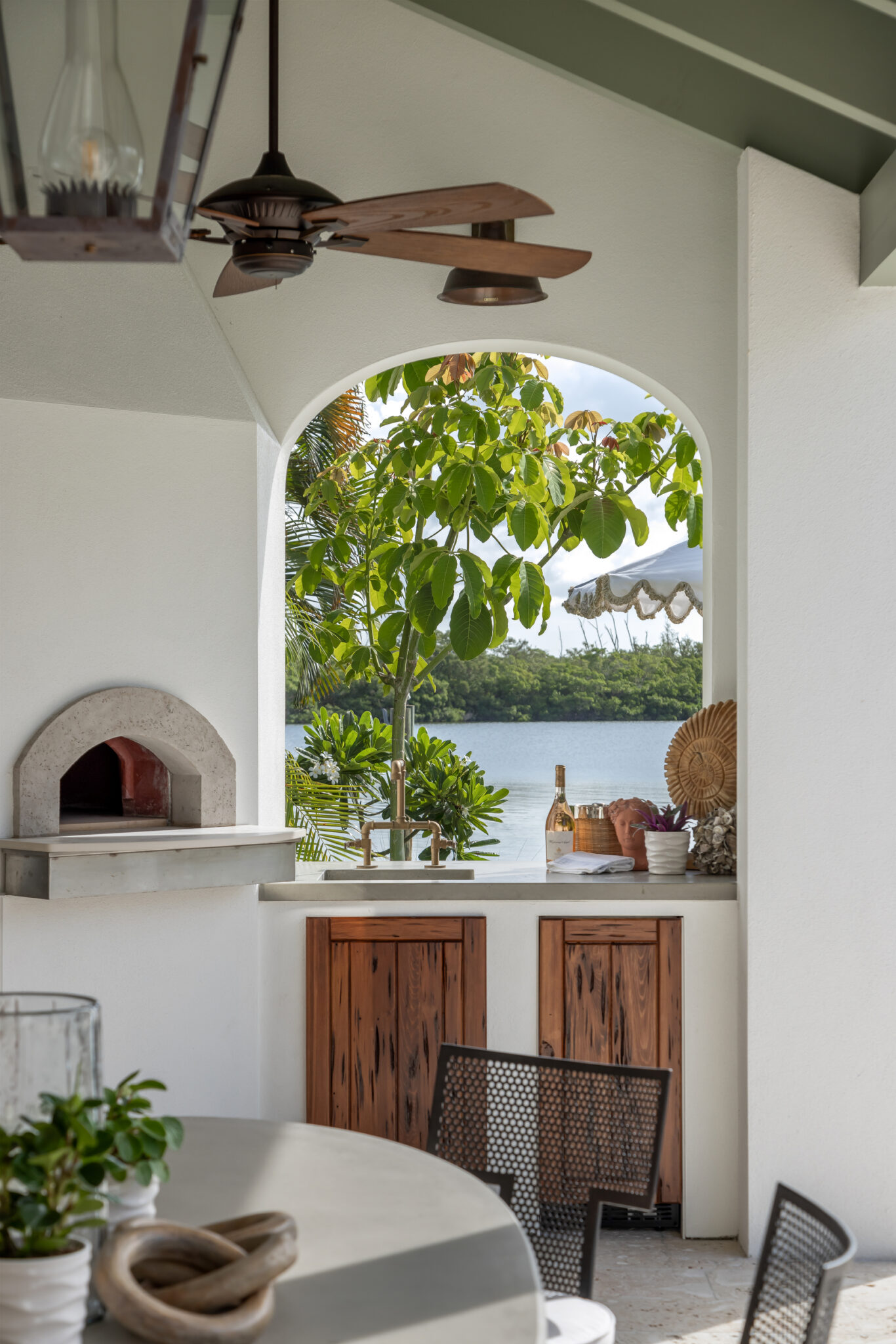 Outdoor pizza oven under an arched opening on the loggia