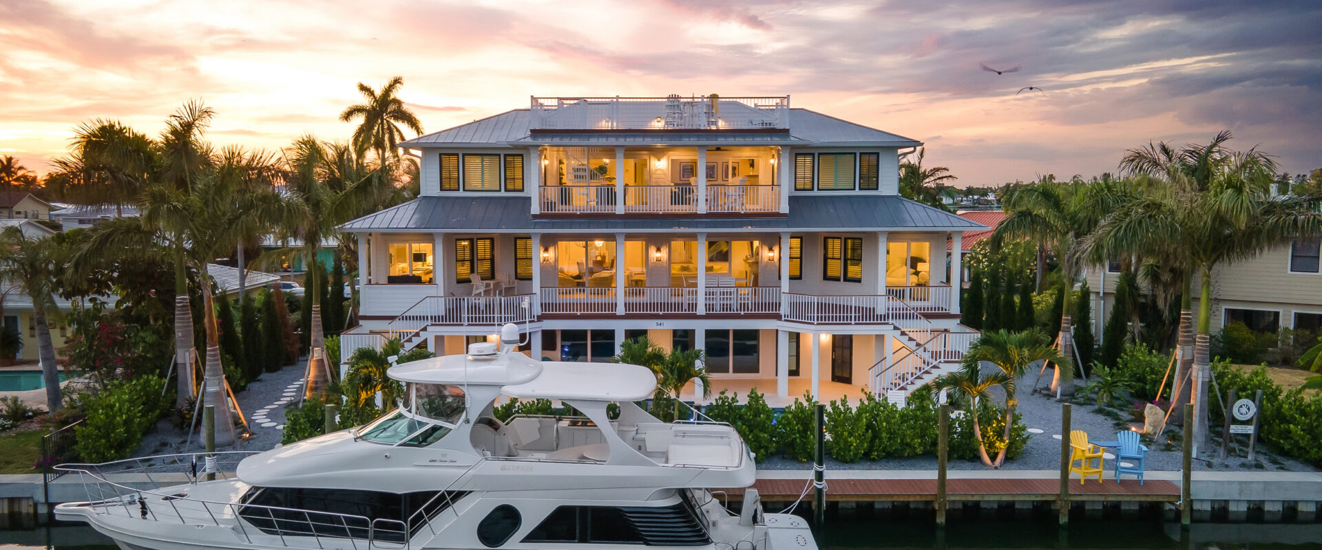 Coastal Haven at sunset with a yacht at its private dock on the canal