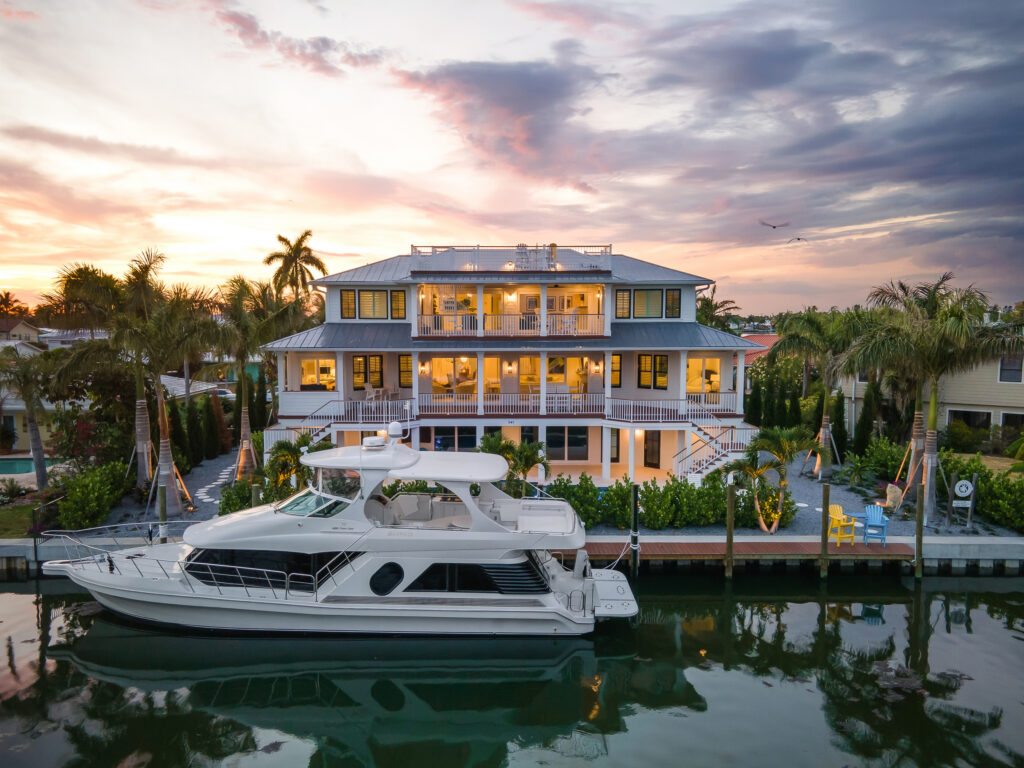Coastal Haven at sunset with a yacht at its private dock on the canal