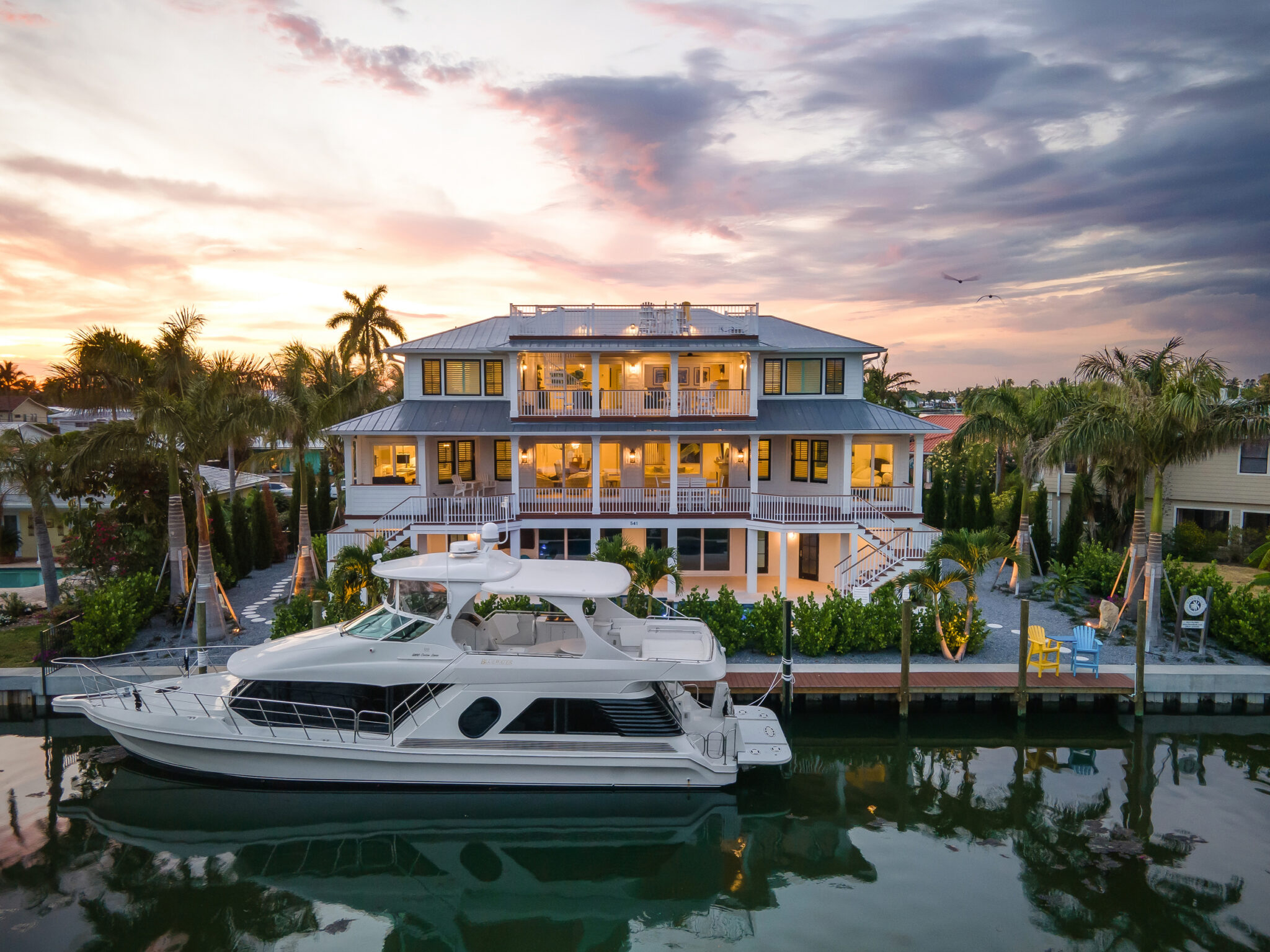Coastal Haven at sunset with a yacht at its private dock on the canal