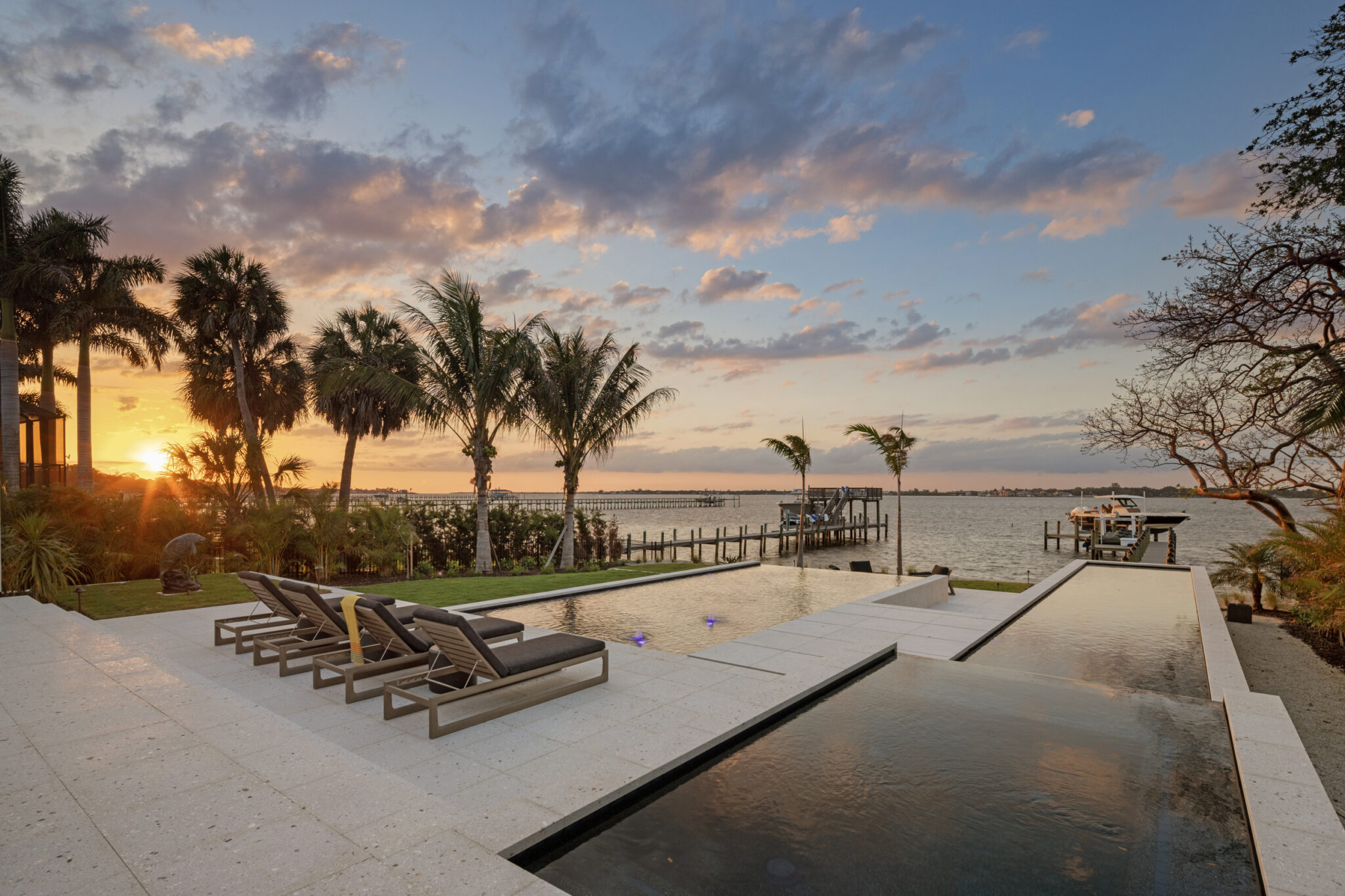 Pool terrace and lounge chairs at sunset over the Manatee River