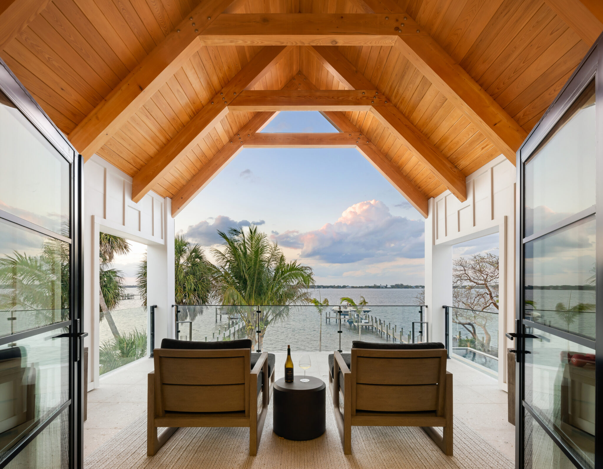 Covered porch under a cedar gable framing the river view