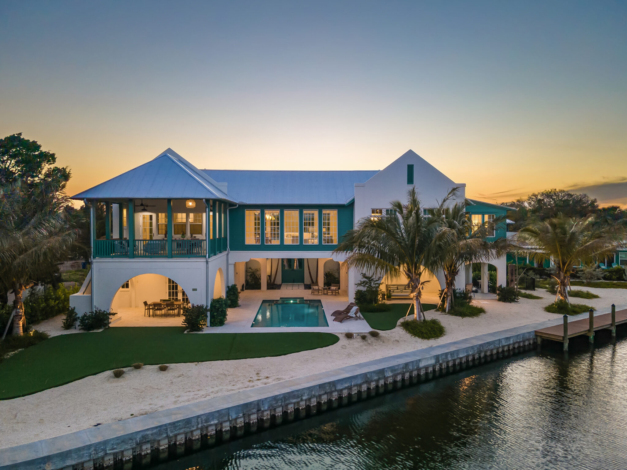 Bimini Bay House from the water at dusk, with seawall and pool