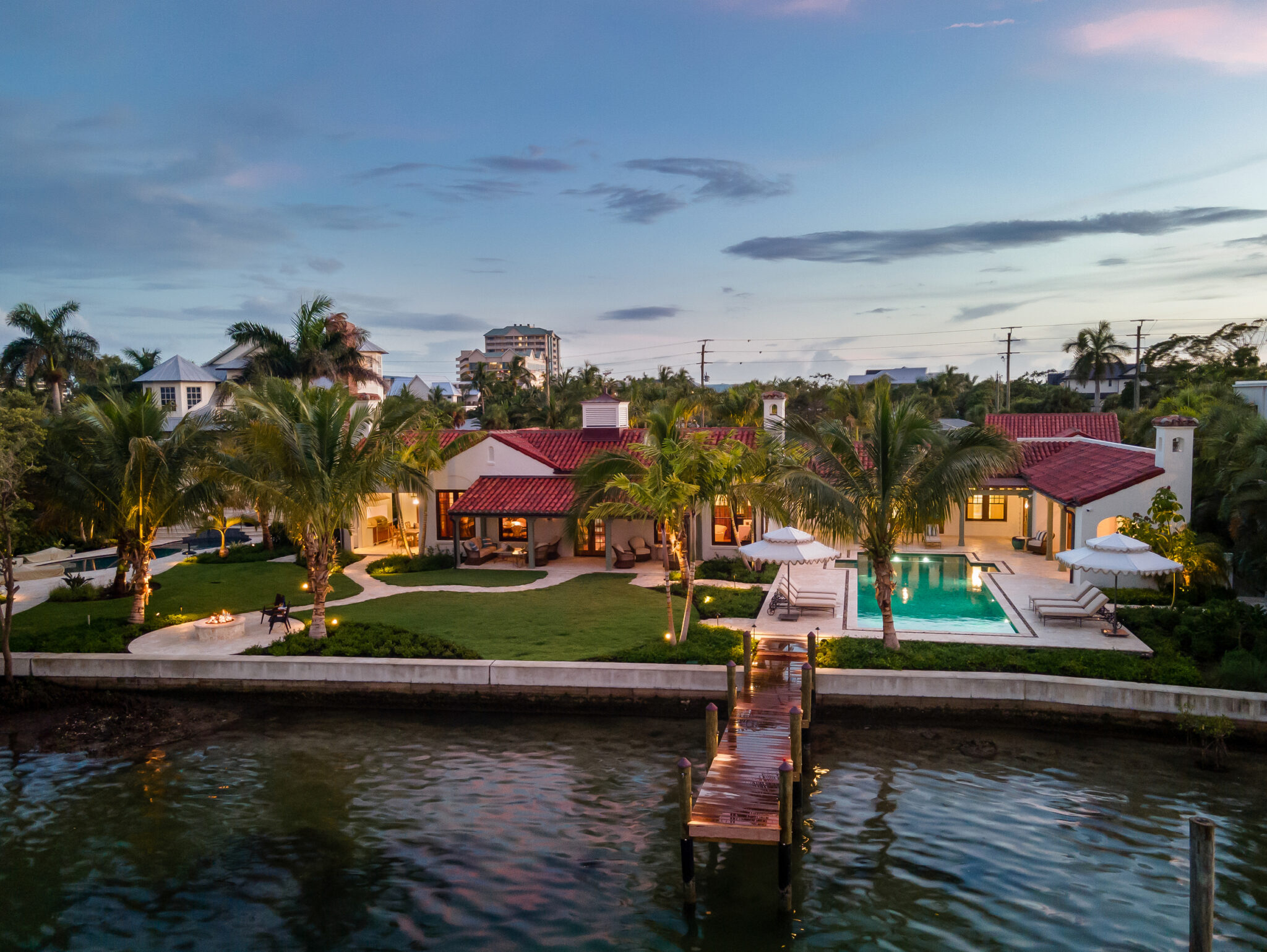 Van Wezel Estate from the water at dusk, with the dock and pool