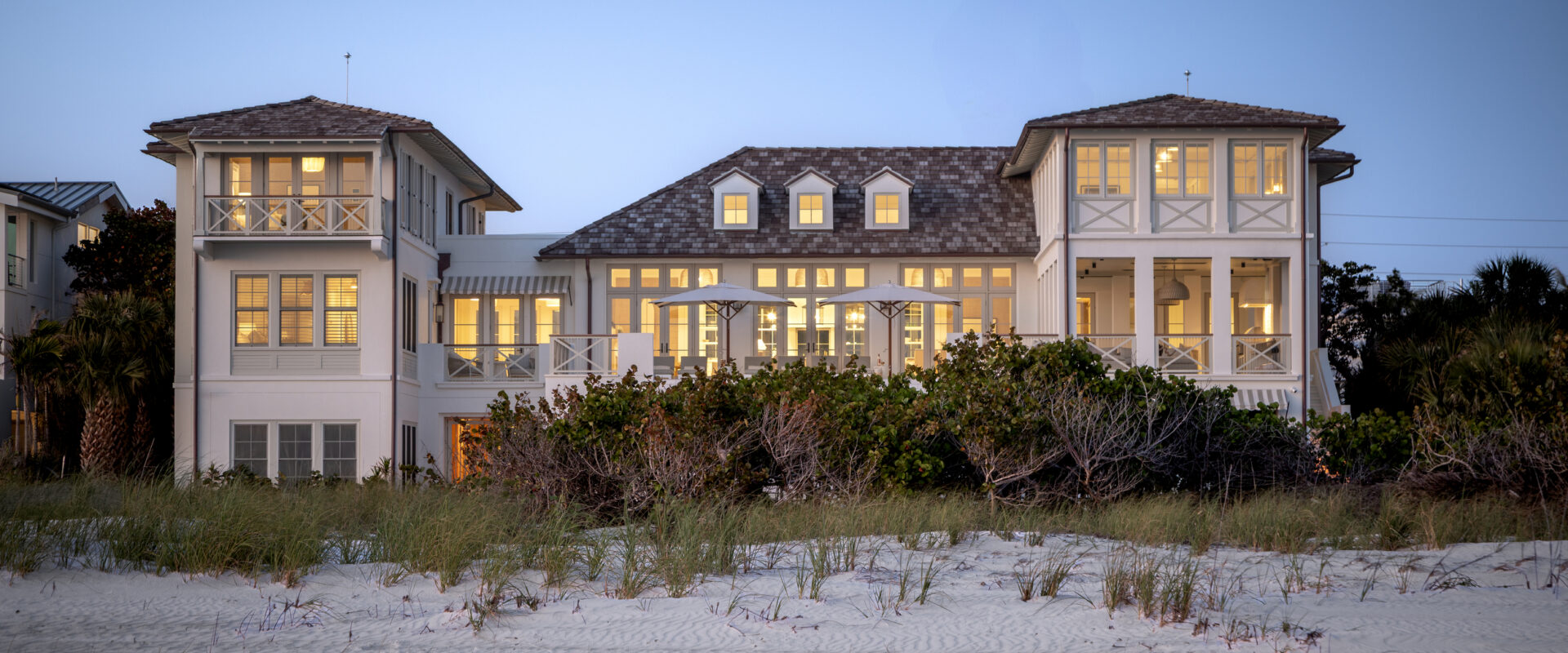 Evening exterior of the North Shore Residence, a traditional beachfront custom home on Anna Maria Island
