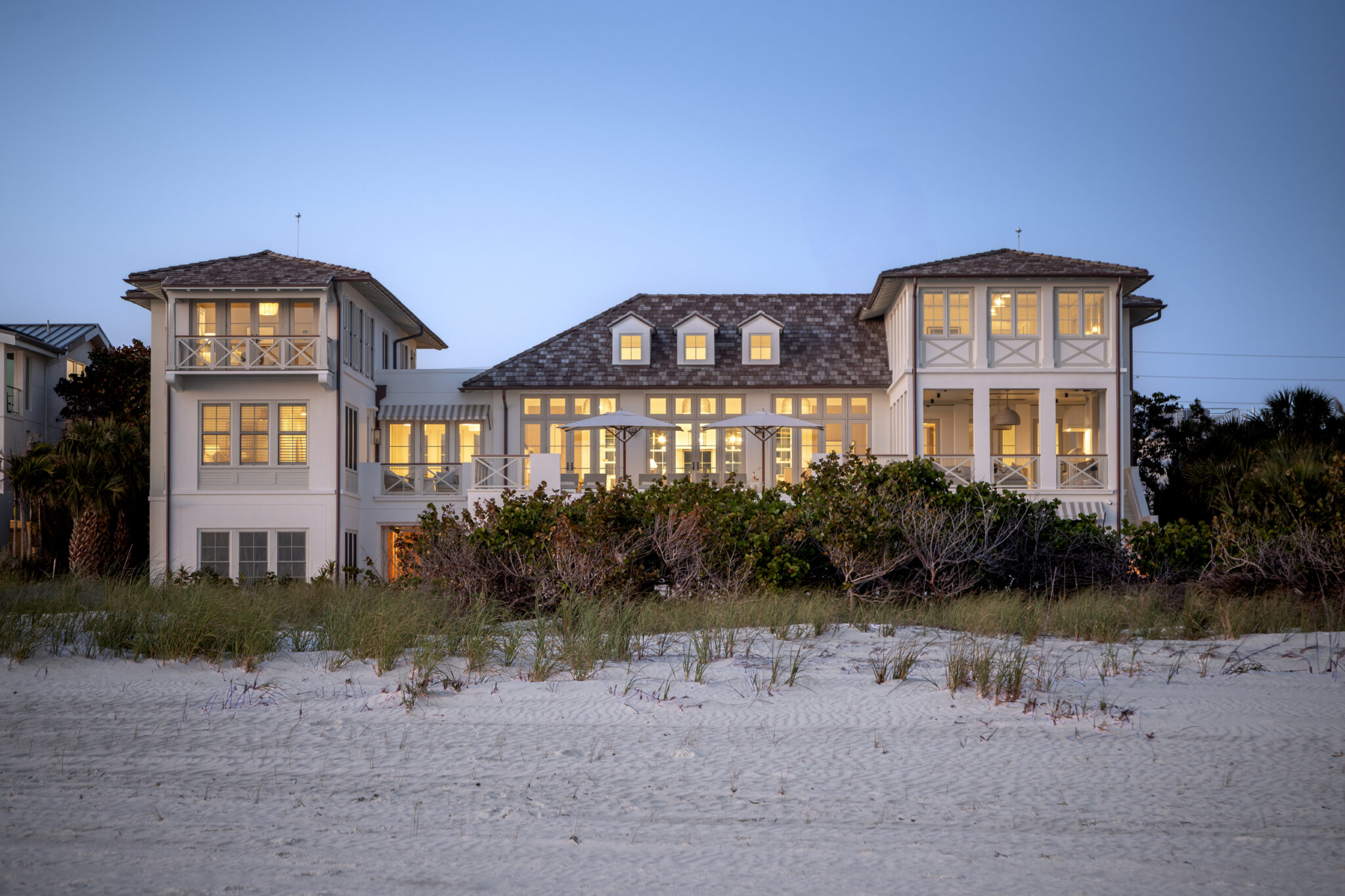Evening exterior of the North Shore Residence, a traditional beachfront custom home on Anna Maria Island