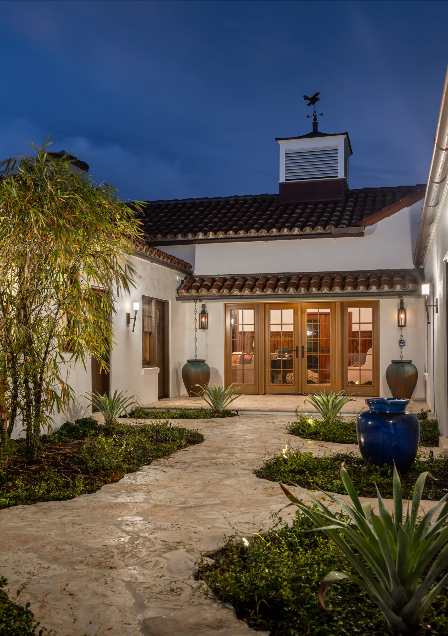 Courtyard entry with a cupola and a garden path