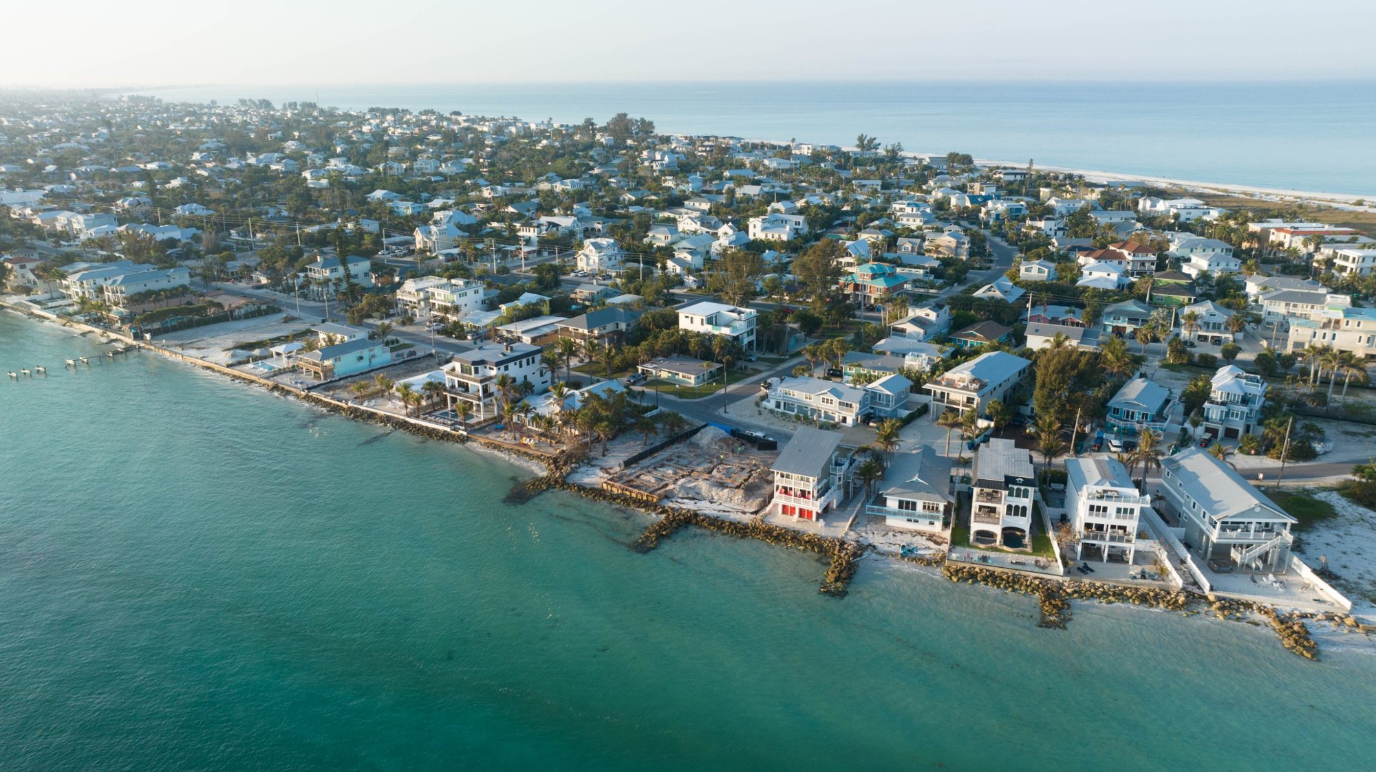Wide aerial view of the lot under construction on the bay at the north end of Anna Maria Island