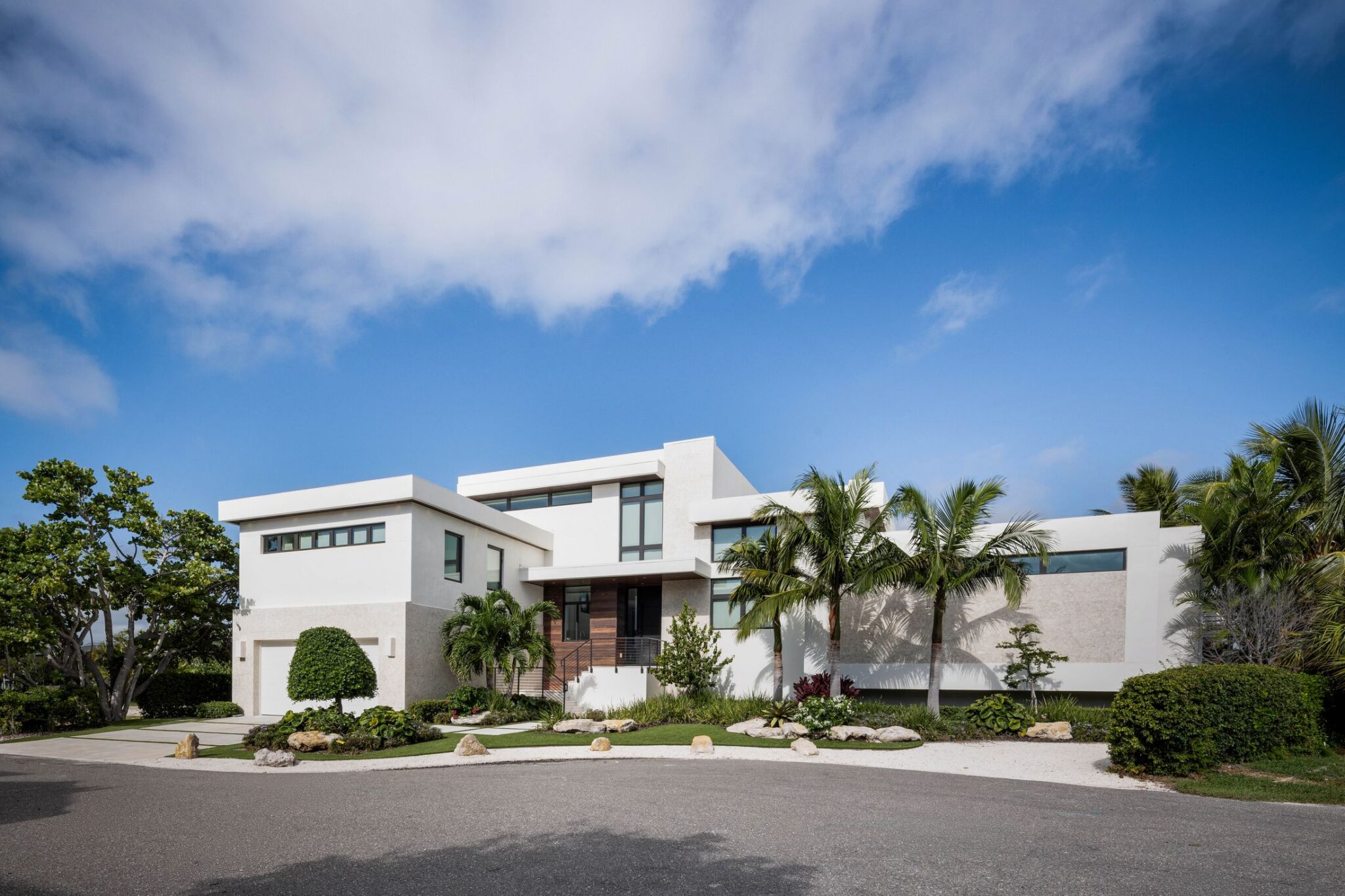 Street front of Bayview Residence, a white modern home with flat roofs and clerestory windows on Longboat Key