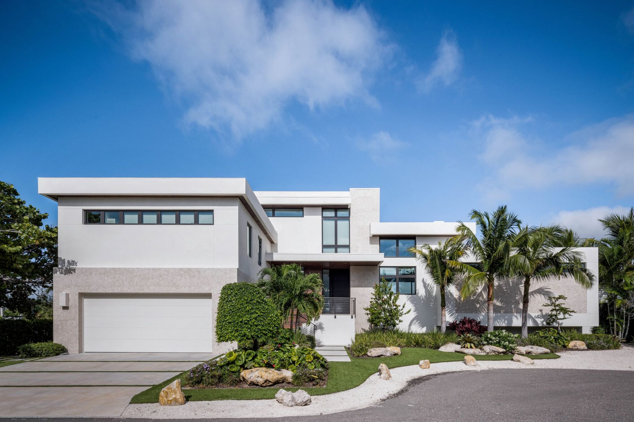 Front of Bayview Residence showing the garage wing, clerestory windows and landscaped entry walk
