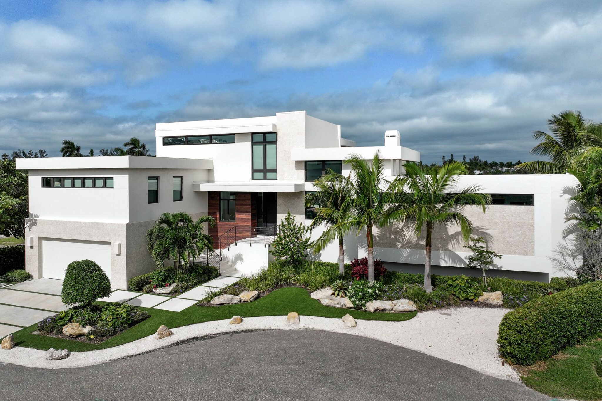 Street front of Bayview Residence on Longboat Key, a modern home in stucco, stone and wood