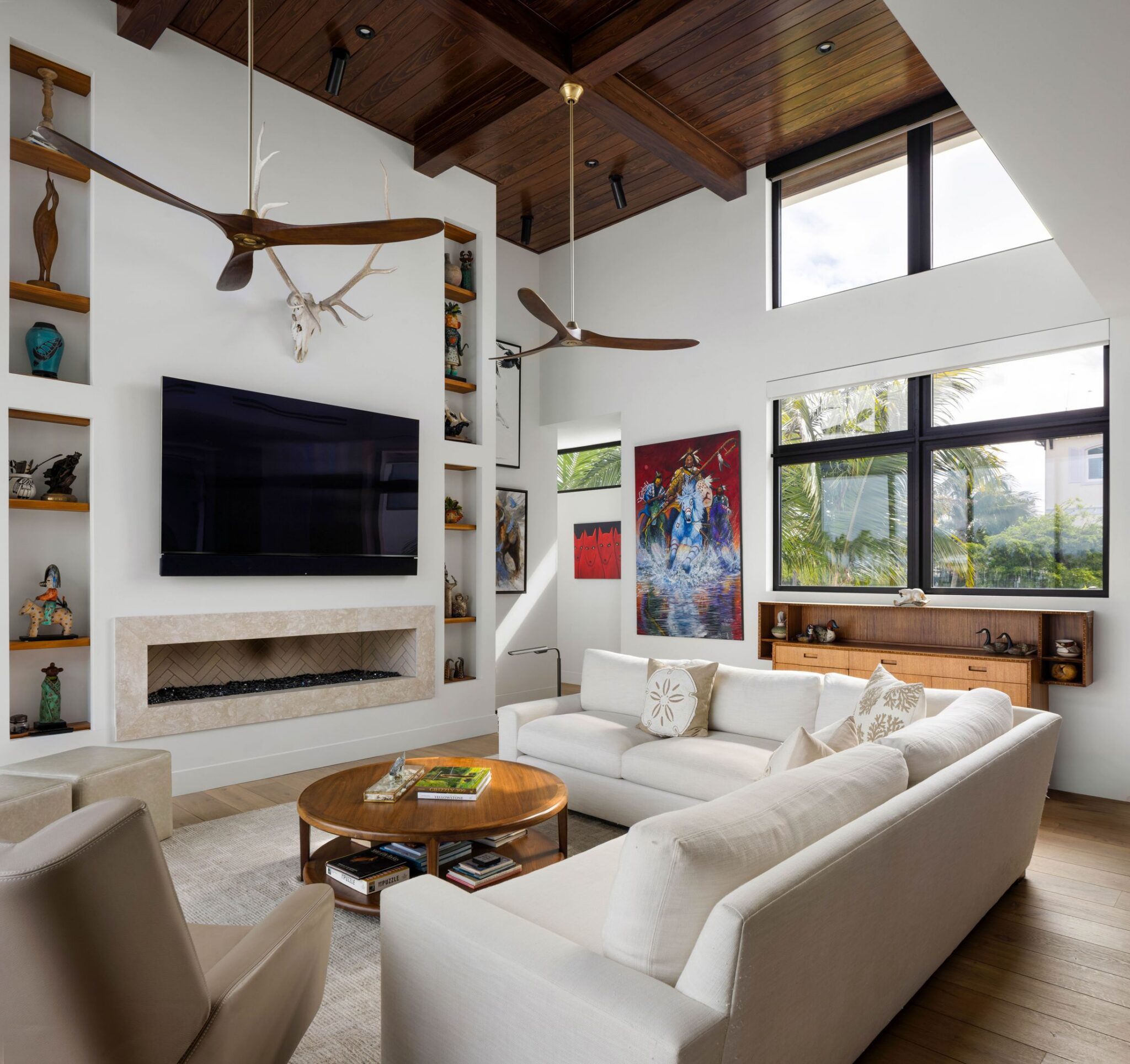 Fireplace wall framed by display shelves and clerestory windows in the two-story living room