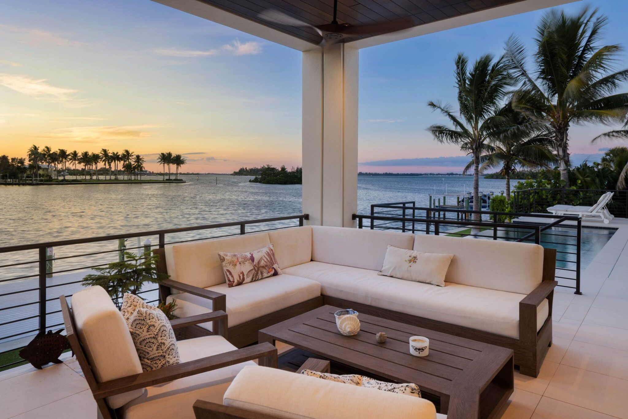 Covered terrace seating overlooking the bay and mangrove islands at sunset