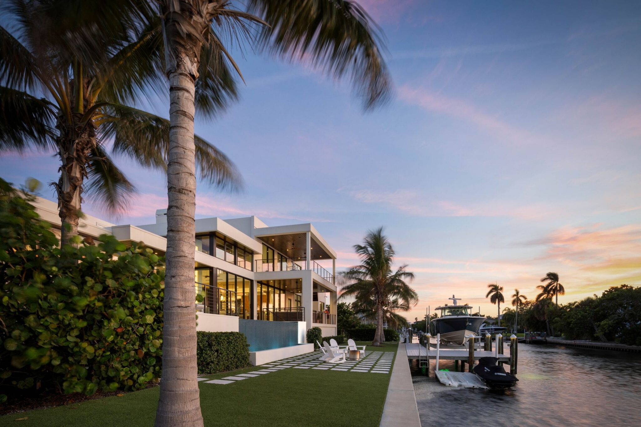 Rear of Bayview Residence at dusk from the seawall, with the pool and dock