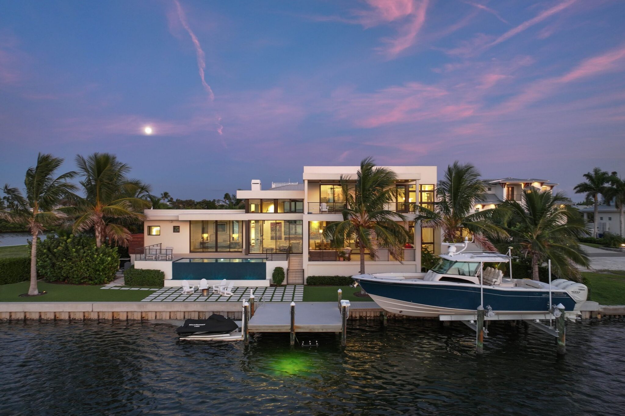 Bay side of Bayview Residence at twilight seen from the water, with the moon rising