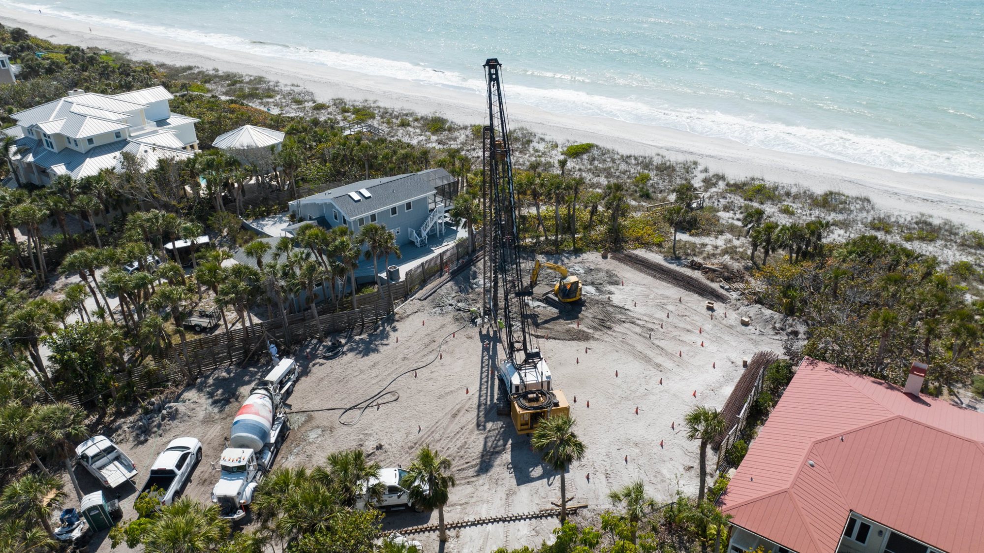 Aerial view of the pile rig on the Gulf-front lot, with the beach beyond