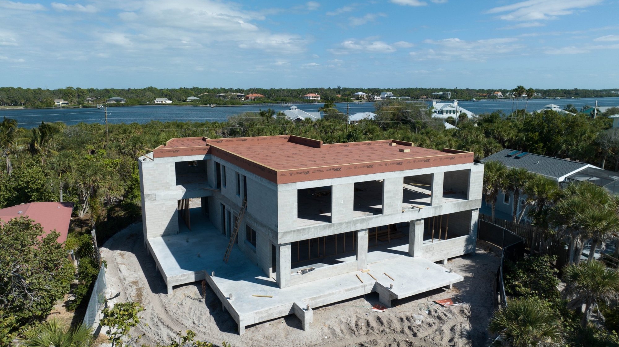 Aerial view of the roof sheathed, looking across the island to Lemon Bay