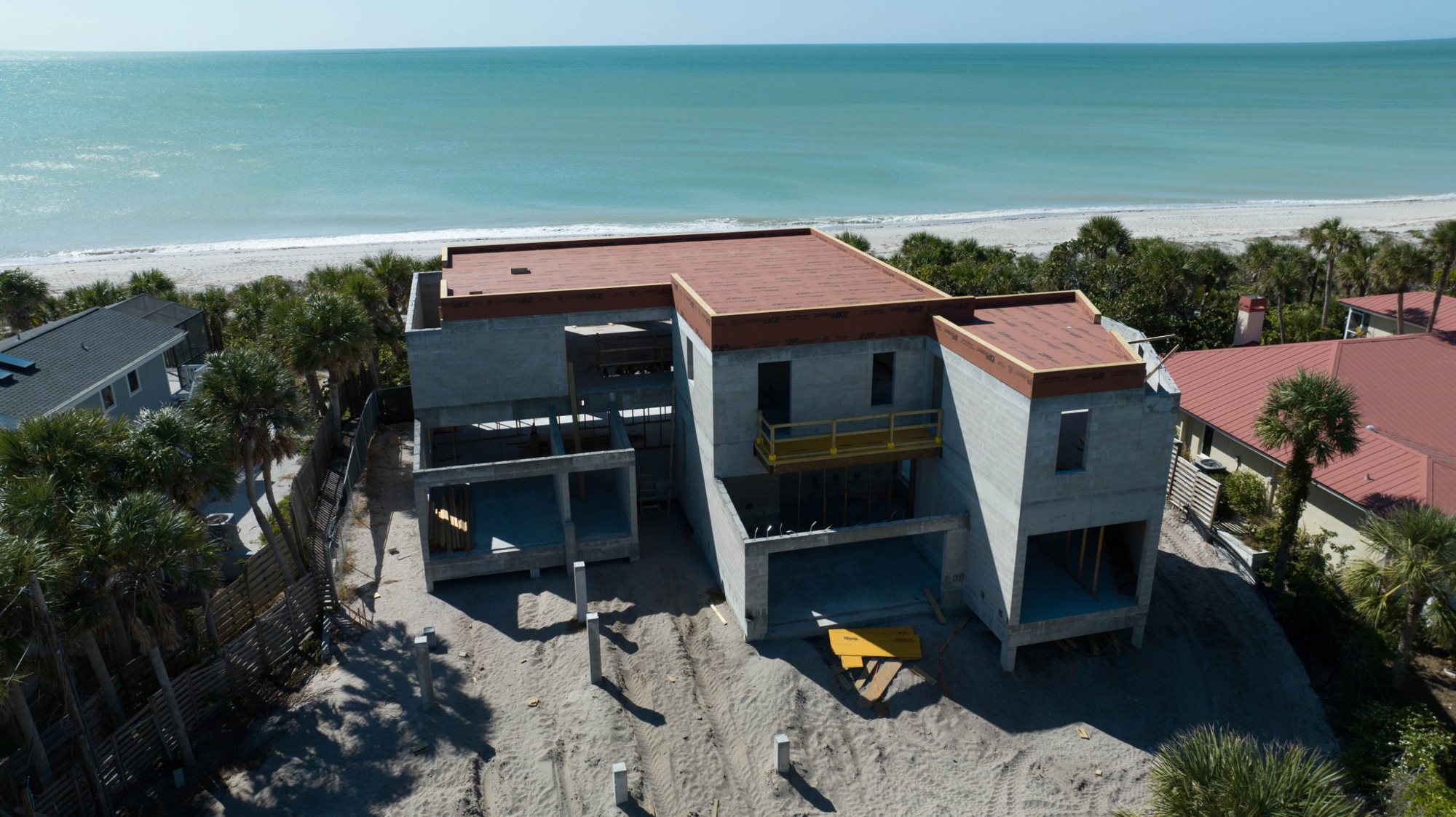 Aerial view of the roof sheathed, looking out to the Gulf