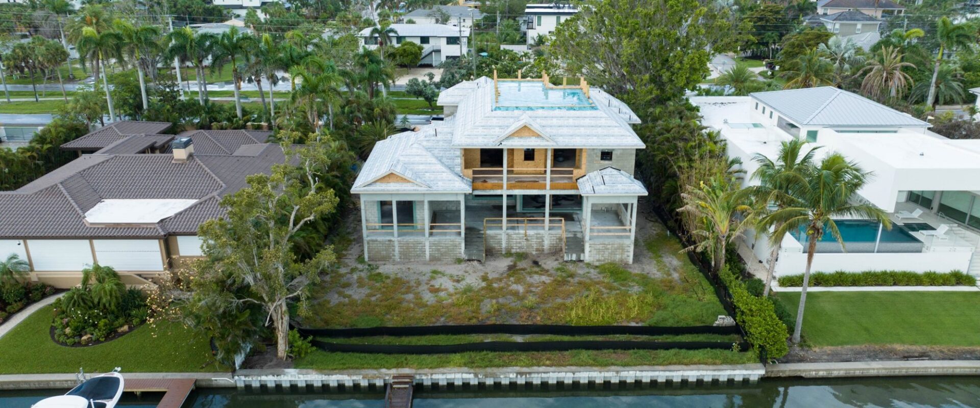 Aerial view from the canal of the house with the roof dried in