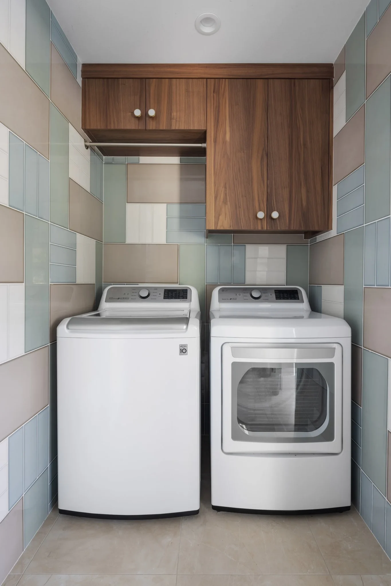 A laundry room with a washing machine on the left and a dryer on the right, both in white