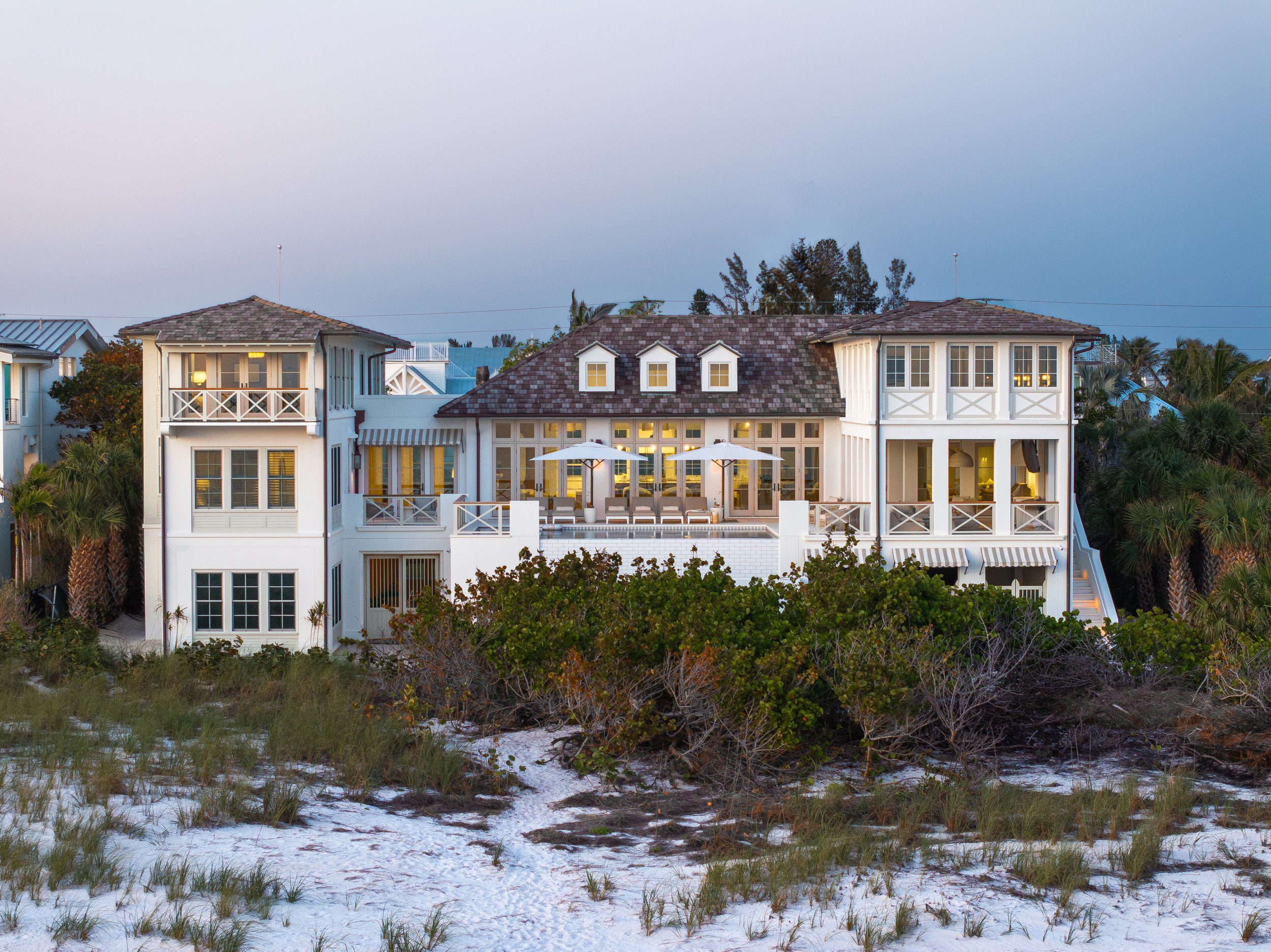 North Shore Residence at dusk, seen across the dunes on Anna Maria Island