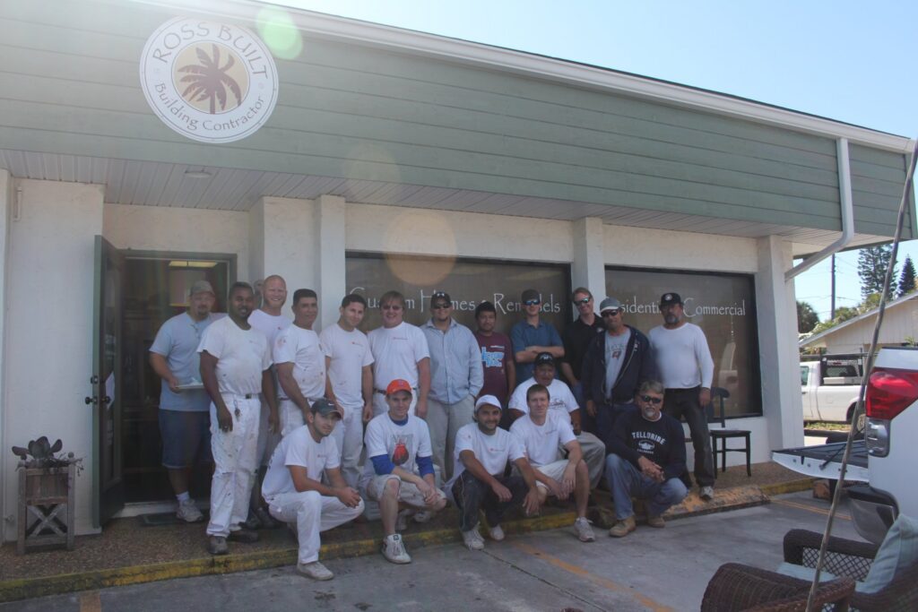 Greg Ross and subcontractors outside the first Ross Built office on Marina Drive at the first subcontractor appreciation party