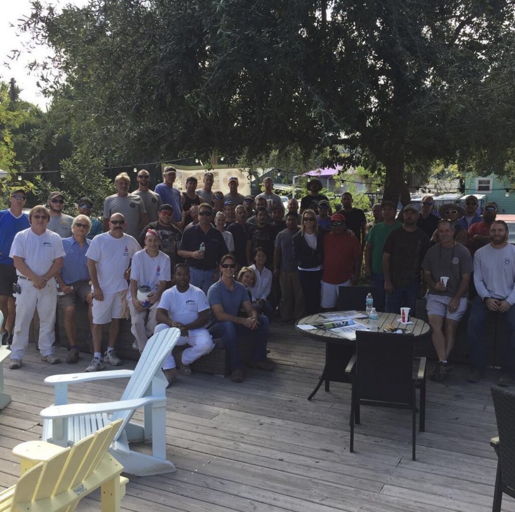 Ross Built subcontractors, trade partners and team gathered on a deck under an oak tree for the ten-year subcontractor appreciation party, 2016