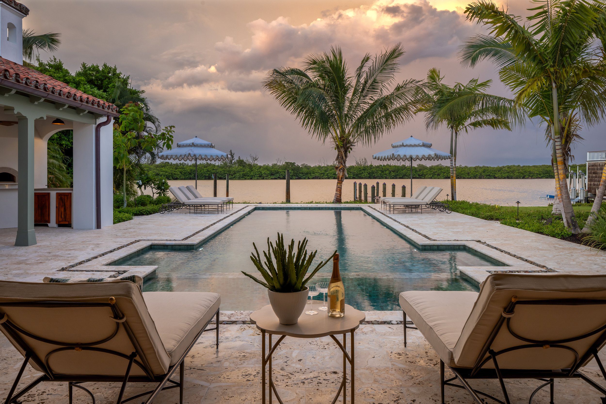 Pool terrace and lounge chairs at sunset at the Van Wezel Estate on Lido Key